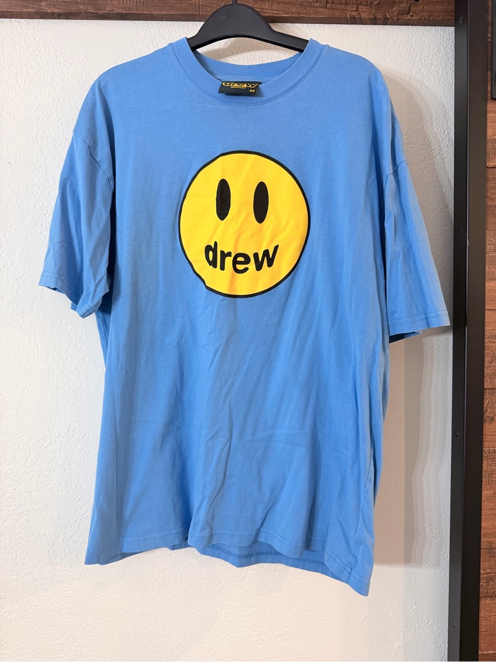 drew house sky blue tee with yellow smiley logo